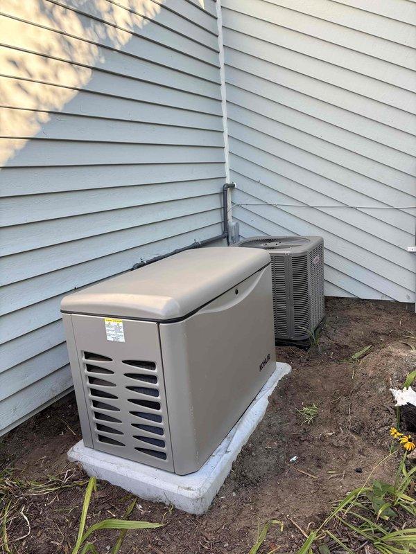 Successfully installed 26KW Kohler standby generator with 200A service upgrade at residential property. Coordinated utility disconnect and reconnect services, obtained electrical permit, and completed all required inspections including gas pressure testing. Generator unit was positioned on concrete pad in side yard utility area with proper clearances, connected gray PVC conduit and refrigerant lines secured with mounting brackets along exterior siding, and integrated with existing electrical system. All work performed to code specifications and passed final inspection.