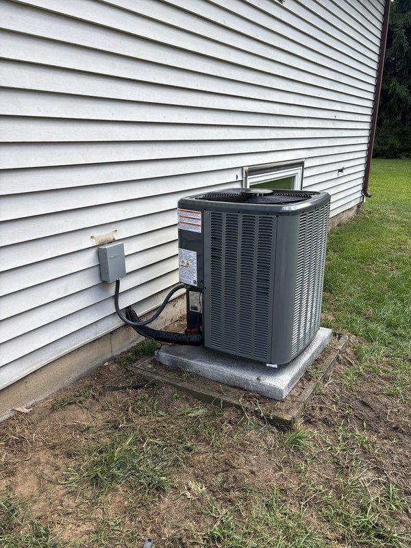 Completed full HVAC system installation including new furnace and air conditioning unit. Outdoor condensing unit installed on concrete pad with proper electrical disconnect and conduit routing to exterior wall. Indoor furnace equipment installed in basement utility area with appropriate venting and drainage systems. All equipment secured, electrical connections completed per code, and system tested for proper operation.