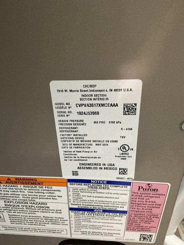 Responded to water leak complaint with AC unit dripping on ceiling from upstairs location. Upon inspection, documented HVAC unit specifications showing Goodman CAC/BDP model CVPVA3617XM0EAAA manufactured May 2024, utilizing R-410A refrigerant. Examined condensate drainage system and internal components including control board wiring and electrical connections to identify source of water intrusion. Photographed unit nameplate data and internal wiring configuration for service records and further diagnostic evaluation.