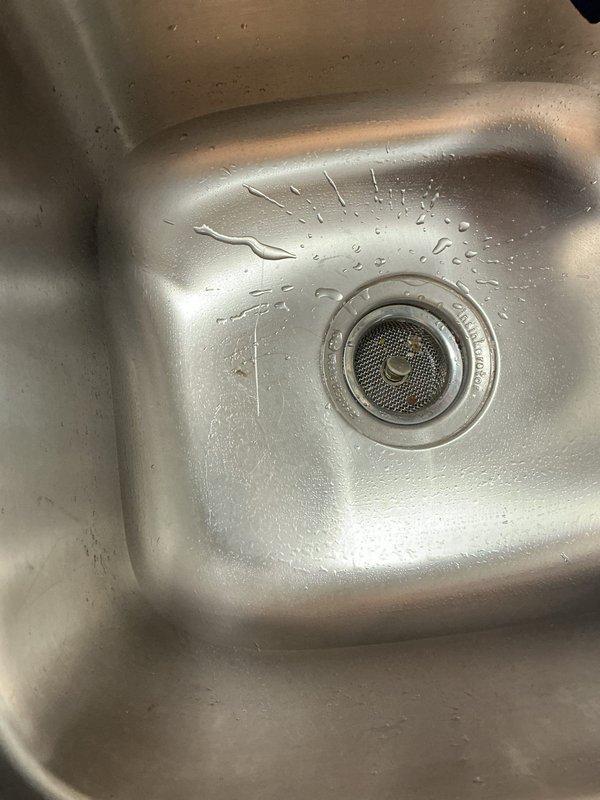 Responded to callback regarding recently installed kitchen faucet. Customer expressed dissatisfaction with faucet selection and reported active leak from the installation completed earlier this week. Upon inspection, documented current condition of double-basin stainless steel sink and existing drain assemblies. Assessed faucet installation and identified source of leak. Discussed alternative faucet options with customer to address aesthetic preferences and ensure proper selection for replacement. Prepared work area for faucet removal and reinstallation with customer-approved fixture to resolve both the leak issue and customer satisfaction concerns.