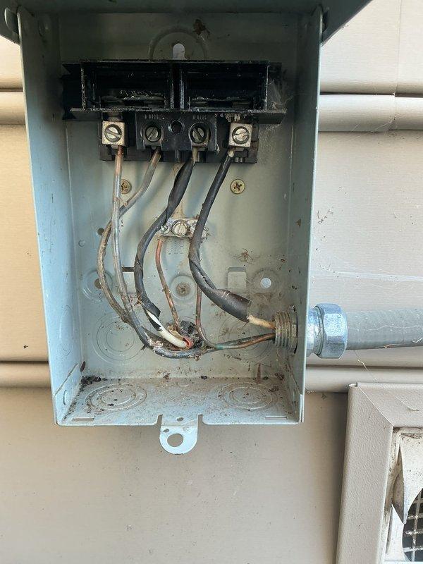 Completed annual cooling maintenance on 15-year-old Carrier AC system. Performed standard tune-up procedures including system inspection, refrigerant level check, and electrical connection evaluation. Discovered and documented significant debris accumulation and possible insect nest material in exterior electrical junction box at disconnect. Noted weathering, oxidation, and corrosion present on junction box enclosure and terminal connections due to environmental exposure. Cleaned accessible debris from electrical enclosure and verified secure wire connections at terminal block. System operational upon completion of maintenance visit.