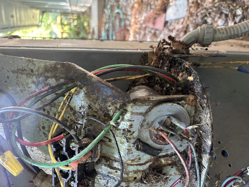 Completed annual cooling maintenance on 24-year-old ICP system. Upon inspection, discovered severe corrosion on blower motor assembly and electrical connections within air handler cabinet, with extensive rust deterioration on motor mounting plate and compromised wire insulation on multiple conductors. Exterior conduit entry point showed accumulated debris and weathered components with exposed wiring connections requiring attention. Documented equipment condition with photos for customer review and recommended immediate evaluation for blower motor replacement and electrical connection restoration due to safety concerns and advanced corrosion that could lead to system failure.