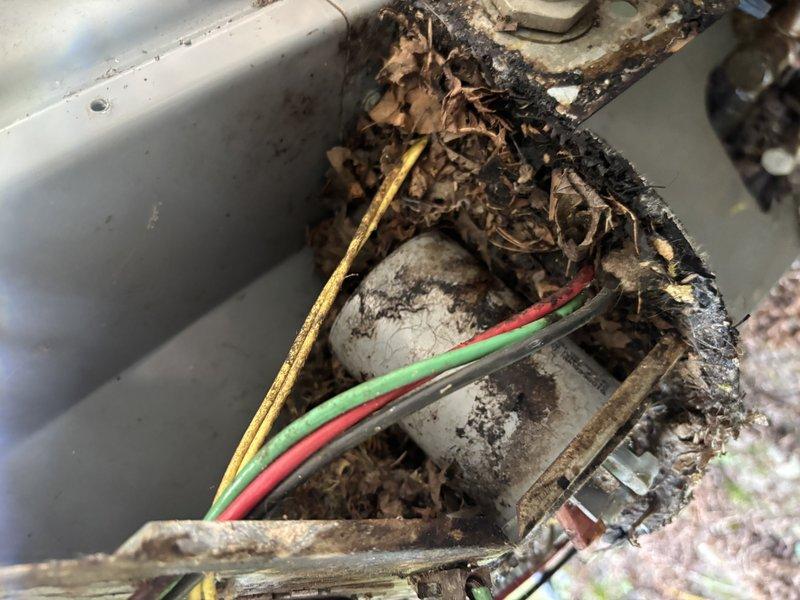 Completed annual cooling maintenance on 24-year-old ICP system. Upon inspection, discovered severe corrosion on blower motor assembly and electrical connections within air handler cabinet, with extensive rust deterioration on motor mounting plate and compromised wire insulation on multiple conductors. Exterior conduit entry point showed accumulated debris and weathered components with exposed wiring connections requiring attention. Documented equipment condition with photos for customer review and recommended immediate evaluation for blower motor replacement and electrical connection restoration due to safety concerns and advanced corrosion that could lead to system failure.