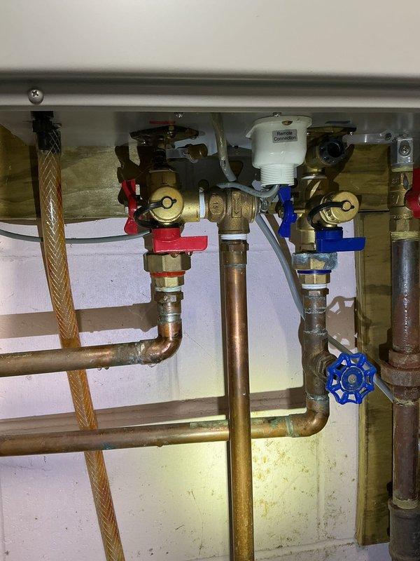 Responded to service call for Rheem tankless water heater experiencing calcium buildup issues. Upon inspection, found significant mineral accumulation on heat exchanger and evidence of scale buildup affecting unit performance. Performed complete descaling flush of system using appropriate cleaning solution, inspected all internal components including heat exchanger coils, condensate collection system, and control board. Verified proper operation of isolation valves, pressure relief systems, and gas valve assembly. Cleaned condensate pan and drainage pathways. Unit tested and restored to normal operating condition with improved flow rate and temperature consistency.