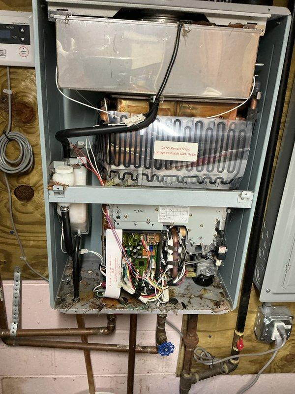 Responded to service call for Rheem tankless water heater experiencing calcium buildup issues. Upon inspection, found significant mineral accumulation on heat exchanger and evidence of scale buildup affecting unit performance. Performed complete descaling flush of system using appropriate cleaning solution, inspected all internal components including heat exchanger coils, condensate collection system, and control board. Verified proper operation of isolation valves, pressure relief systems, and gas valve assembly. Cleaned condensate pan and drainage pathways. Unit tested and restored to normal operating condition with improved flow rate and temperature consistency.