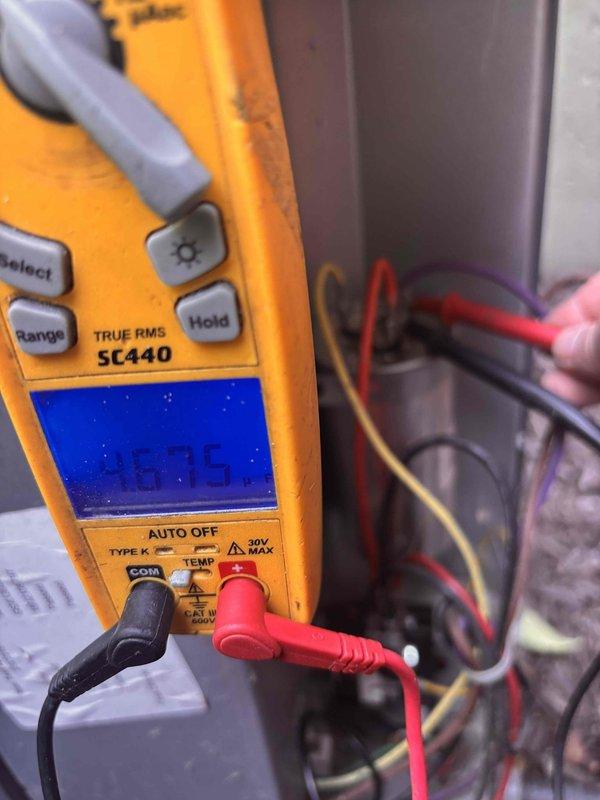 Completed annual cooling maintenance on 10-year-old Goodman unit. Performed comprehensive system diagnostics including electrical measurements with digital multimeter, recording operational readings at 47.5 (likely amperage or voltage depending on circuit tested). Inspected and tested capacitor (CAP050450440CT), verified proper wiring connections on purple, copper, and yellow conductor runs, and confirmed all brass terminals were secure. System operating within normal parameters; no repairs required at this time.