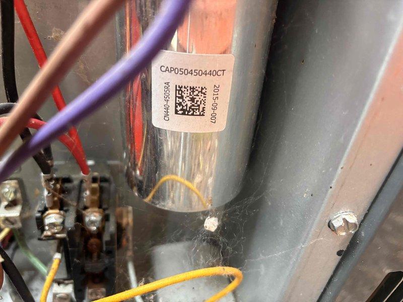Completed annual cooling maintenance on 10-year-old Goodman unit. Performed comprehensive system diagnostics including electrical measurements with digital multimeter, recording operational readings at 47.5 (likely amperage or voltage depending on circuit tested). Inspected and tested capacitor (CAP050450440CT), verified proper wiring connections on purple, copper, and yellow conductor runs, and confirmed all brass terminals were secure. System operating within normal parameters; no repairs required at this time.