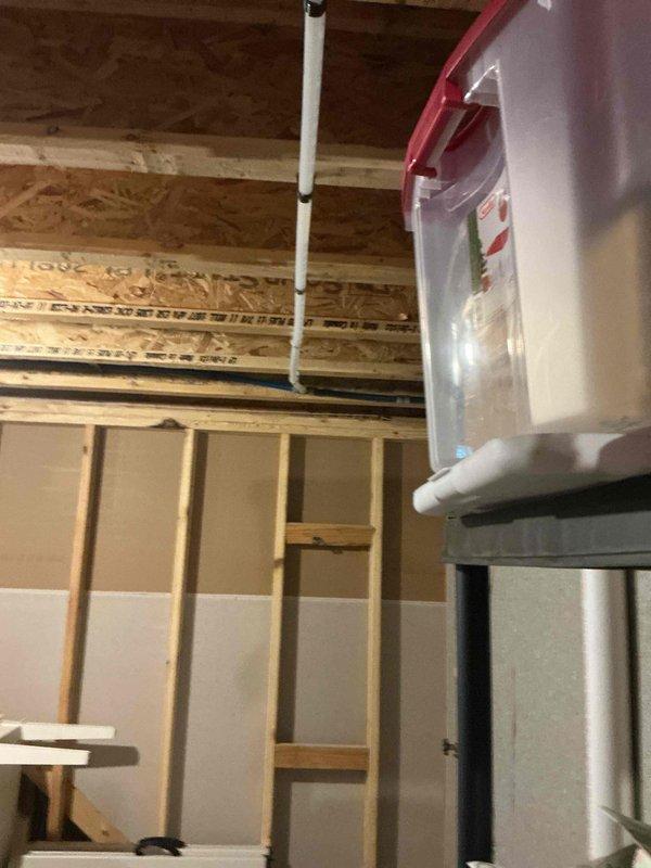 Completed installation of backup sump pump system with associated plumbing connections. Installed sump basin in concrete floor with converging PVC drainage lines and copper water supply piping, secured electrical wiring to discharge lines, and integrated system with existing basement infrastructure to provide redundant water removal capability.
