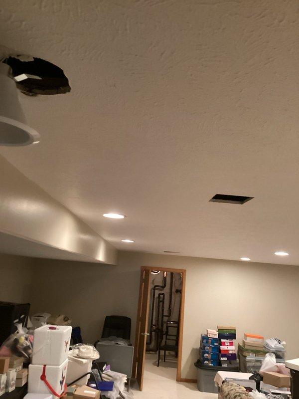 Responded to plumbing leak investigation behind drywall. Upon arrival, accessed ceiling cavity through existing recessed light fixture opening to locate source of moisture affecting drywall. Removed light fixture from housing to inspect above ceiling area and identify water source from concealed piping. Documented wet drywall conditions and exposed ceiling cavity for further leak source identification. Photos captured of affected areas including ceiling access points and recessed fixture removal for diagnostic purposes.