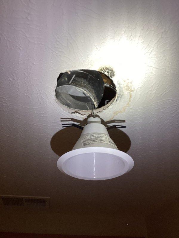 Responded to plumbing leak investigation behind drywall. Upon arrival, accessed ceiling cavity through existing recessed light fixture opening to locate source of moisture affecting drywall. Removed light fixture from housing to inspect above ceiling area and identify water source from concealed piping. Documented wet drywall conditions and exposed ceiling cavity for further leak source identification. Photos captured of affected areas including ceiling access points and recessed fixture removal for diagnostic purposes.