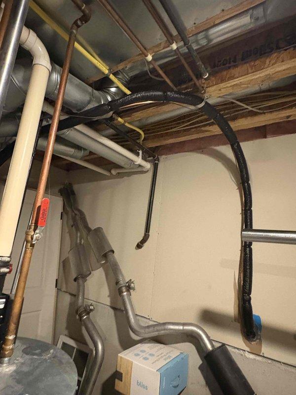 Completed full air conditioning system replacement at residential property. Removed existing outdoor condenser unit and installed new condensing unit on concrete pad against exterior wall near gas meter and electrical service panel. Unit positioned with proper clearances from foundation and landscaping. Interior work included installation of new evaporator coil in basement mechanical space with connections to existing ductwork system. Ran refrigerant lines, established proper refrigerant charge, and verified system pressures. Connected electrical service, tested all safety controls, and confirmed proper airflow throughout system. System commissioned and operating within manufacturer specifications upon completion.