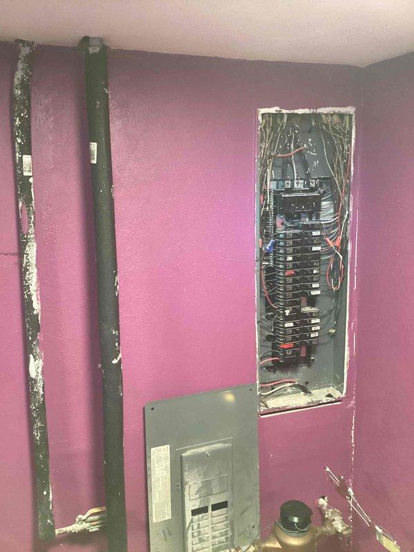 Conducted on-site assessment for generator installation estimate. Evaluated existing electrical infrastructure, including main service panel with exposed breakers and wiring configuration. Documented current electrical panel capacity and condition to determine compatibility with proposed generator system. Assessed exterior service entry point, downspout placement, and overhead utility line clearances for optimal generator and transfer switch positioning. Photographed interior electrical panel and exterior building corner to support equipment sizing recommendations and installation planning.
