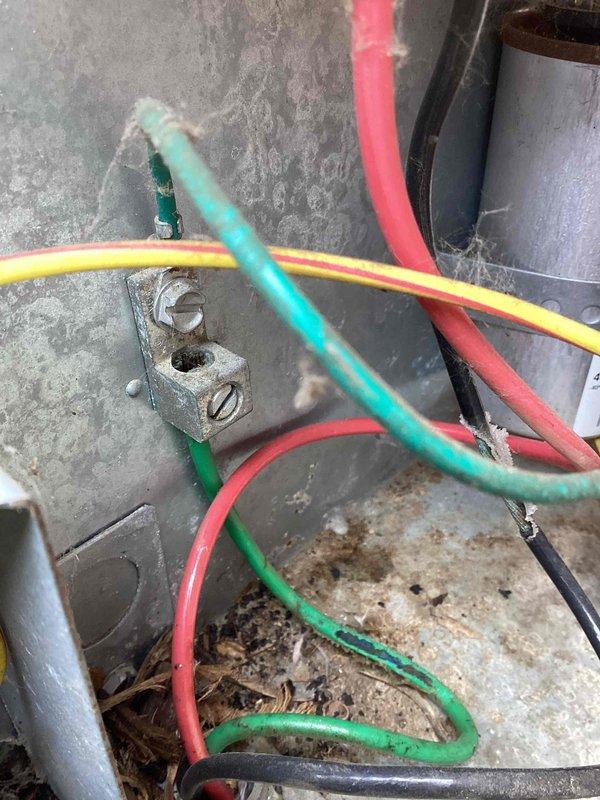 # No Cool Service Call - YORK System

Responded to no cooling condition affecting entire home on an approximately eleven-year-old YORK air conditioning system. Upon inspection of outdoor condensing unit, found extensive rust and corrosion on metal base pan and interior surfaces, indicating prolonged moisture exposure. Electrical panel showed significant accumulation of dirt, debris, and organic matter including leaves in bottom of cabinet. Multiple wire connections exhibited oxidation and green corrosion patina on terminal blocks.

Identified failed dual-run capacitor (40+5 MFD) as primary cause of no cooling condition. Capacitor showed signs of deterioration consistent with age and environmental exposure. Replaced defective capacitor with new OEM-equivalent unit. Cleaned electrical connections and terminals to ensure proper conductivity. Removed accumulated debris from cabinet interior. Verified all wire connections secure and properly terminated.

Started system and confirmed compres