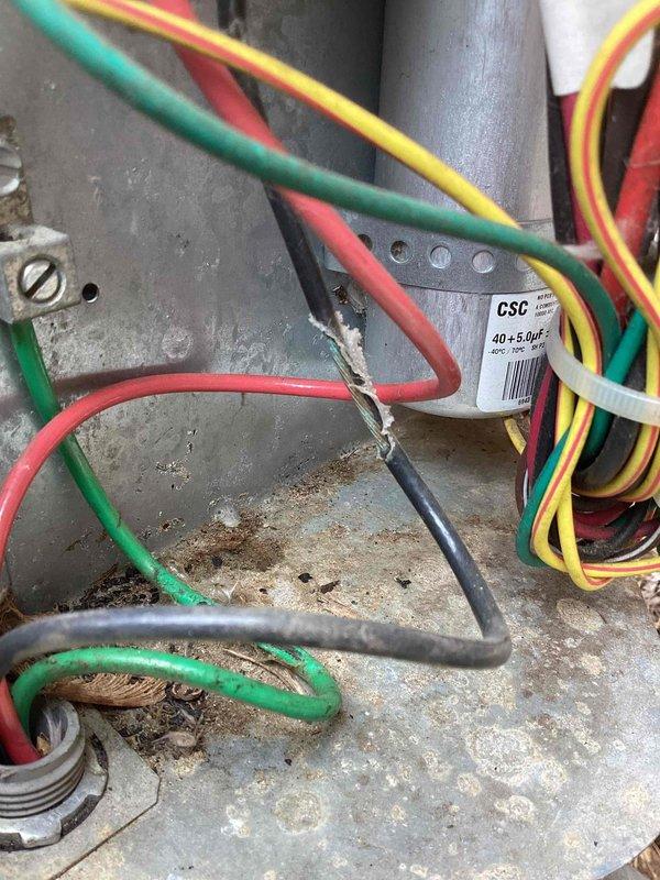 # No Cool Service Call - YORK System

Responded to no cooling condition affecting entire home on an approximately eleven-year-old YORK air conditioning system. Upon inspection of outdoor condensing unit, found extensive rust and corrosion on metal base pan and interior surfaces, indicating prolonged moisture exposure. Electrical panel showed significant accumulation of dirt, debris, and organic matter including leaves in bottom of cabinet. Multiple wire connections exhibited oxidation and green corrosion patina on terminal blocks.

Identified failed dual-run capacitor (40+5 MFD) as primary cause of no cooling condition. Capacitor showed signs of deterioration consistent with age and environmental exposure. Replaced defective capacitor with new OEM-equivalent unit. Cleaned electrical connections and terminals to ensure proper conductivity. Removed accumulated debris from cabinet interior. Verified all wire connections secure and properly terminated.

Started system and confirmed compres