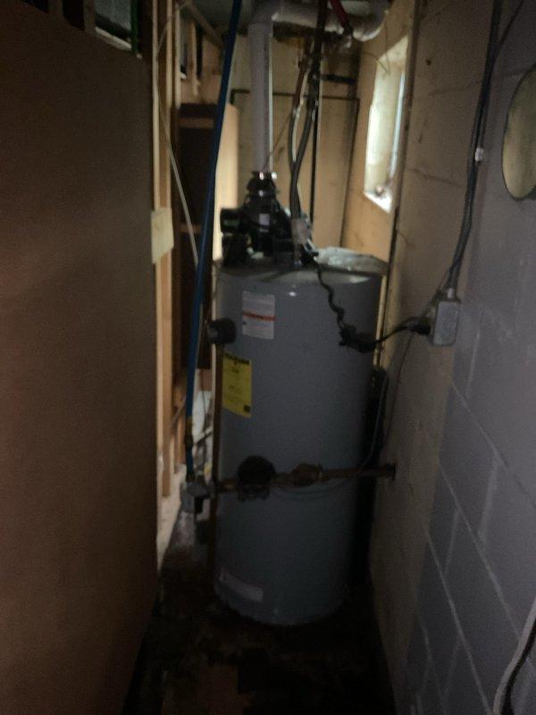 Responded to service call for leaking water heater approximately 10 years old. Upon arrival, performed visual inspection of unit and surrounding utility space to identify source of leak. Documented existing conditions with photographs showing water heater installation, piping connections, and overall equipment configuration. Unit exhibited signs of age-related deterioration consistent with end of typical service life for residential water heaters. Provided assessment and recommendations to customer regarding repair versus replacement options based on unit age and condition.