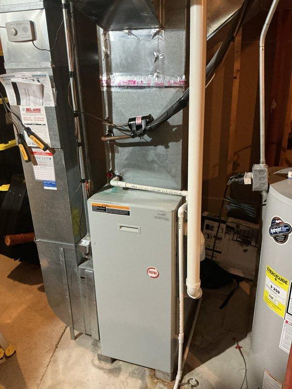 Responded to no-cooling complaint on 20+ year old central air conditioning system affecting entire home. Upon arrival, found outdoor condensing unit completely inoperative with no power to compressor or condenser fan motor. Performed diagnostic testing at outdoor unit and traced electrical circuit back to indoor air handler and furnace location in basement. Identified failed contactor preventing outdoor unit from receiving proper voltage signal from thermostat. Replaced defective contactor with appropriate replacement part rated for system specifications. Verified proper voltage at contactor coil and through load contacts. Tested system operation through complete cooling cycle, confirming compressor and condenser fan motor startup, proper amperage draw on both components, and adequate airflow from indoor blower assembly. System restored to normal cooling operation with all components functioning within manufacturer specifications.