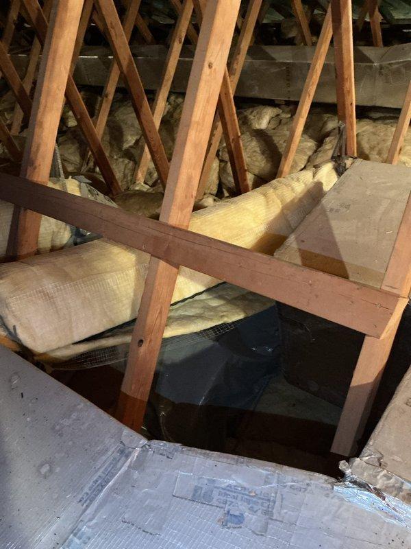 Responded to no cooling call on Unit 1 air conditioning system. Accessed attic space and inspected HVAC ductwork and insulation. Documented existing conditions including flexible duct connections, fiberglass insulation installation, and attic structural components for service records and warranty documentation.