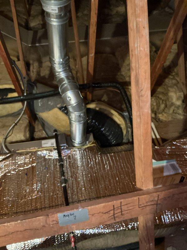 Responded to no cooling call on Unit 1 air conditioning system. Accessed attic space and inspected HVAC ductwork and insulation. Documented existing conditions including flexible duct connections, fiberglass insulation installation, and attic structural components for service records and warranty documentation.