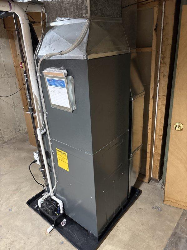 Completed full HVAC system installation including new furnace and air conditioning condenser unit. Installed outdoor AC condenser on concrete pad with proper refrigerant line connections to residence, mounted electrical disconnect, and ensured adequate clearances from fence and siding. Indoor furnace unit installed on platform in basement with new air handler, plenum assembly, and flexible ductwork connections. Ran PVC condensate drain lines with proper pitch and termination. Verified all electrical connections, tested system operation, and confirmed proper airflow throughout. System commissioned and left in full working order.