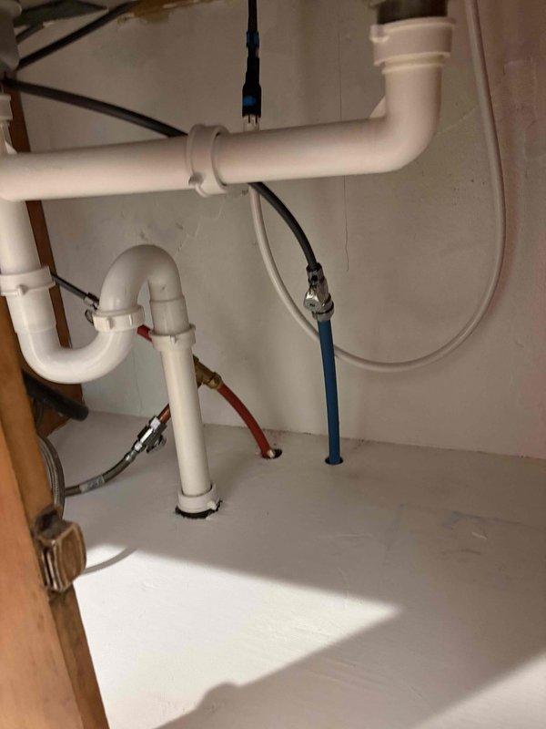 Responded to kitchen faucet service call for malfunctioning spray nozzle that was continuously spraying and leaking. Diagnosed faulty spray head diverter valve causing constant water flow through the side sprayer. Replaced defective spray nozzle assembly and tested operation to confirm proper function. Verified all connections under sink were secure and no additional leaks were present in the supply lines or P-trap drainage system.