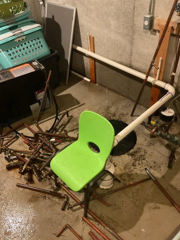 Responded to plumbing leak in basement utility/furnace room that had been ongoing for two weeks. Upon arrival, found significant water accumulation on concrete floor with standing water and multiple puddles throughout the space. Located source of leak in copper piping system suspended from floor joists. Removed and replaced failed section of copper pipe, including associated fittings and mounting brackets. Tested system under pressure to verify repair integrity and confirm no additional leaks present. Cleaned up standing water and verified proper drainage. System restored to full operational status with no further water intrusion detected.