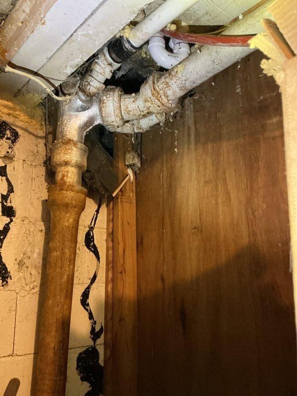 Responded to emergency plumbing call for shower malfunction and active basement leak. Upon arrival, conducted thorough inspection of plumbing system and identified severely corroded copper supply line in basement as primary source of water intrusion. The copper piping exhibited extensive oxidation, rust patina, and structural deterioration with visible water staining on surrounding concrete block walls, indicating prolonged moisture exposure and active leakage.

Assessed jetted bathtub fixture on upper level and determined shower inoperability was directly related to compromised water supply from damaged basement piping. Documented all affected areas with detailed photographs showing corroded copper sections, PVC connections, shut-off valves, and water damage to structural elements for insurance documentation purposes. Photos captured extent of pipe deterioration, mineral deposits, staining patterns, and overall condition of plumbing infrastructure.

Isolated water supply to affected s
