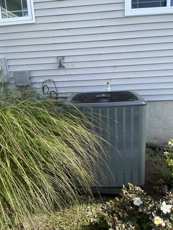 Completed full air conditioning system replacement including outdoor condenser unit and indoor air handler. New condenser was installed on existing concrete pad with proper clearances maintained from landscaping and structure. Indoor air handler was positioned in basement mechanical room with all ductwork connections properly sealed and secured to existing distribution system.