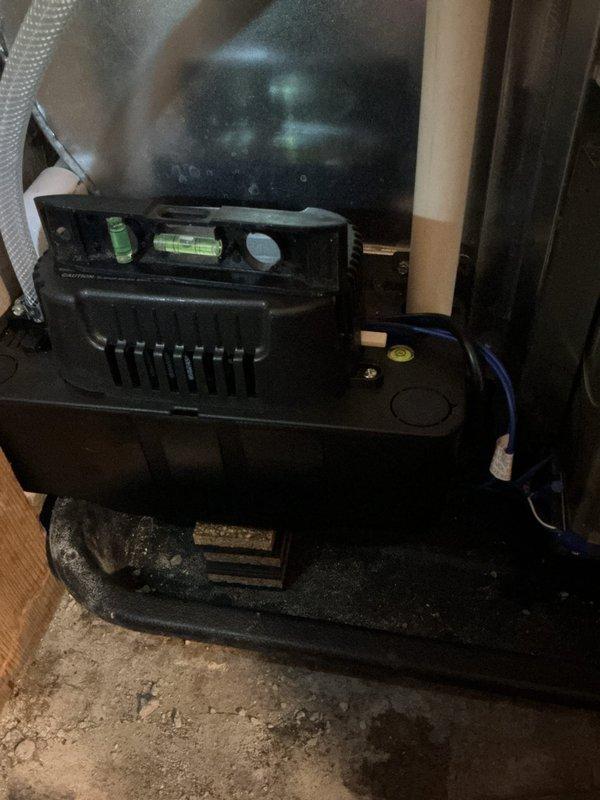 Responded to no cooling call following new installation. Upon arrival, found condensate pump improperly installed and not level, preventing proper drainage and causing system safety shutdown. Leveled and repositioned condensate pump unit on basement floor to ensure proper operation. Verified pump functionality and confirmed system returned to normal cooling operation. Unit now operating as designed with proper condensate removal.