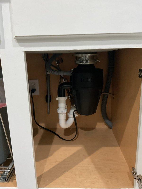 Responded to kitchen sink drain clog complaint. Upon inspection, identified blockage in garbage disposal unit. Cleared obstruction from disposal and verified proper drainage through system. Tested disposal operation and confirmed full functionality of sink drain and all plumbing connections beneath cabinet.