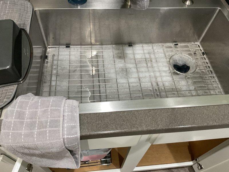 Responded to kitchen sink drain clog complaint. Upon inspection, identified blockage in garbage disposal unit. Cleared obstruction from disposal and verified proper drainage through system. Tested disposal operation and confirmed full functionality of sink drain and all plumbing connections beneath cabinet.