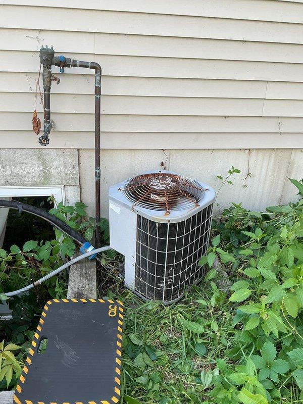 # CP-Cooling Problem Resolution

Responded to service call for 27-year-old air conditioning system that failed to start. Upon arrival, performed diagnostic evaluation of outdoor condensing unit located against exterior wall. Unit exhibited signs of age and deferred maintenance, with significant rust corrosion visible on refrigerant lines and weathered components. Vegetation overgrowth around unit base was noted, potentially restricting airflow to condenser.

Conducted electrical troubleshooting to identify cause of no-start condition. Inspected disconnect, contactor, capacitor, and control wiring for failures. Verified power supply to unit and tested all electrical components for proper operation. Cleared debris and vegetation from around unit perimeter to restore adequate ventilation clearance. 

System was successfully restored to operational status. Advised customer of unit's advanced age and deteriorated condition of refrigerant piping, recommending consideration for system replace