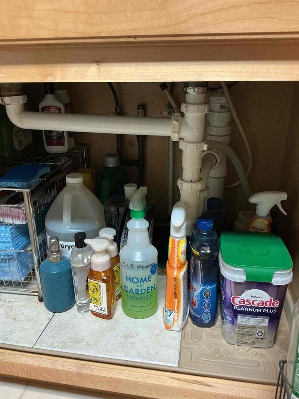Responded to clogged drain call and performed diagnostic inspection of plumbing system. Accessed kitchen sink cabinet and basement drainage lines to identify blockage location. Cleared obstruction from main drain line using professional drain cleaning equipment, restoring proper flow through P-trap and waste piping. Verified all fixtures draining correctly upon completion. Documented existing plumbing configuration with photos for service records.