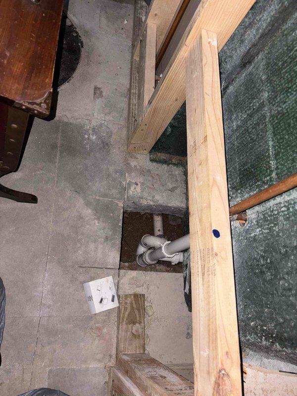 Responded to clogged drain call and performed diagnostic inspection of plumbing system. Accessed kitchen sink cabinet and basement drainage lines to identify blockage location. Cleared obstruction from main drain line using professional drain cleaning equipment, restoring proper flow through P-trap and waste piping. Verified all fixtures draining correctly upon completion. Documented existing plumbing configuration with photos for service records.