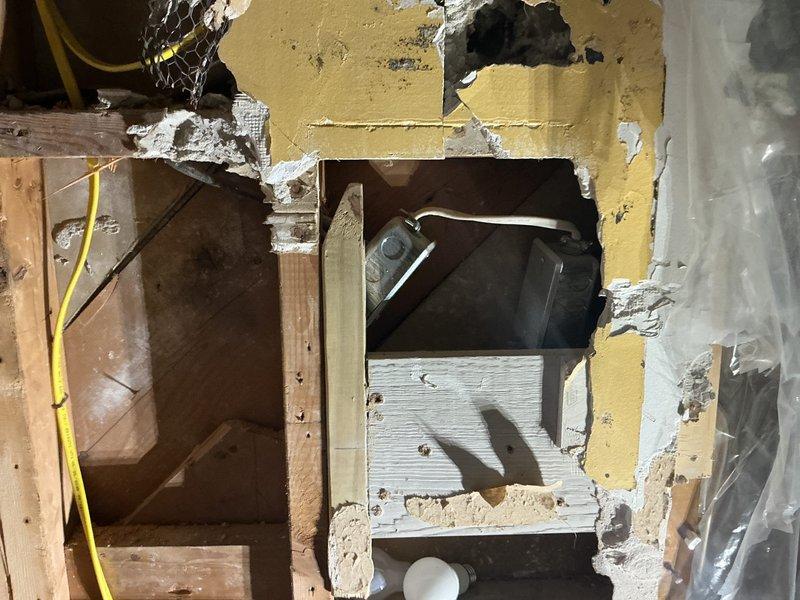 Completed electrical wiring installation for bathroom exhaust fan in residential property. Accessed wall cavity through existing openings, ran new electrical circuit through wall studs, and installed junction box on brick wall surface. Connected wiring to outlet box using proper electrical connections and secured all components according to code requirements.