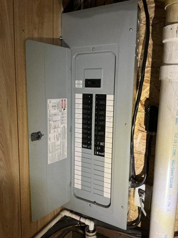 Conducted comprehensive HVAC assessment for new homeowner at 3PM. Evaluated existing Carrier furnace system with associated ductwork and examined electrical panel configuration in unfinished basement area. Documented current equipment conditions, circuit breaker panel setup with main disconnect, and mechanical room layout including furnace, water heater, and distribution systems. Photographed all major components to provide detailed estimate for air conditioning system installation and integration with existing heating infrastructure.