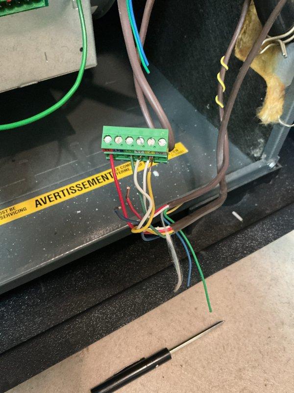 Completed annual cooling system maintenance on 16-year-old unit. Performed comprehensive tune-up including inspection of electrical connections, terminal blocks, and control panel wiring. All electrical components, including multi-wire terminal junctions and safety warning labels, were verified to be secure and functioning properly for continued system operation.