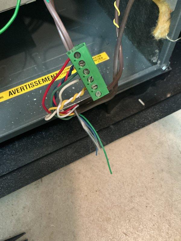 Completed annual cooling system maintenance on 16-year-old unit. Performed comprehensive tune-up including inspection of electrical connections, terminal blocks, and control panel wiring. All electrical components, including multi-wire terminal junctions and safety warning labels, were verified to be secure and functioning properly for continued system operation.