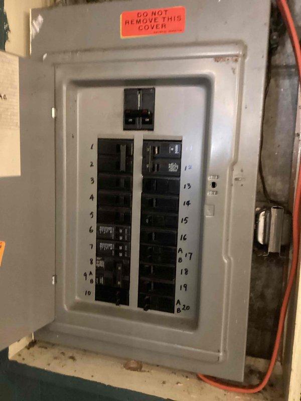 Responded to no-cooling complaint on 15-year-old air conditioning system experiencing intermittent operation. Upon arrival, inspected electrical circuit breaker panel and verified power supply to HVAC equipment. Customer reported temporary restoration of cooling after power cycling the system, but issue recurred. Documented electrical panel configuration and breaker positions for the air conditioning circuit to assess potential electrical supply issues contributing to the intermittent cooling failure.
