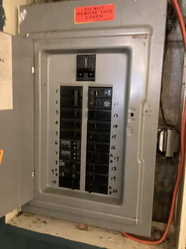 Responded to no-cooling complaint on 15-year-old air conditioning system experiencing intermittent operation. Upon arrival, inspected electrical circuit breaker panel and verified power supply to HVAC equipment. Customer reported temporary restoration of cooling after power cycling the system, but issue recurred. Documented electrical panel configuration and breaker positions for the air conditioning circuit to assess potential electrical supply issues contributing to the intermittent cooling failure.