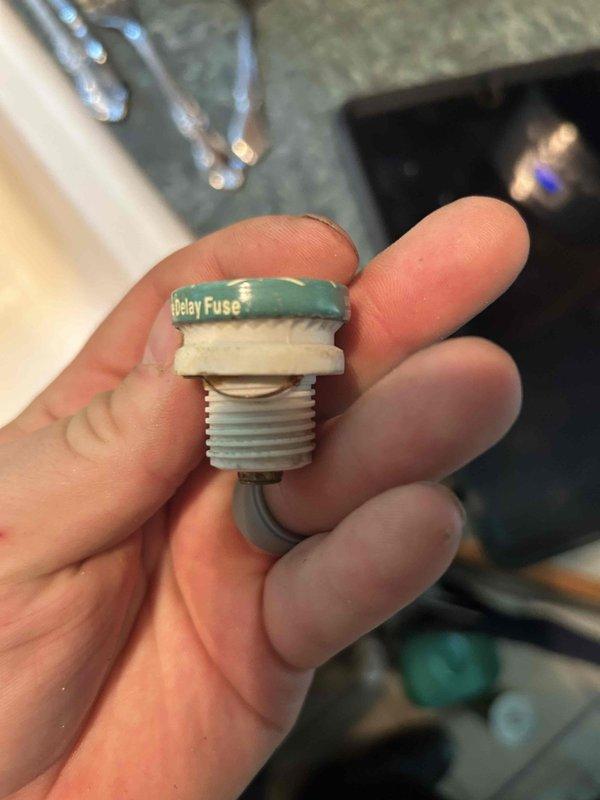 Responded to non-functioning kitchen garbage disposal that had stopped operating three days prior. Found that the reset button would not engage properly, indicating an internal electrical fault. Upon inspection, diagnosed a blown thermal overload fuse within the disposal unit. Removed and replaced the defective 8-amp Type S Buss Fustat delay fuse with new component. Tested unit operation and verified proper function restored. Disposal now operating normally with full grinding capability.