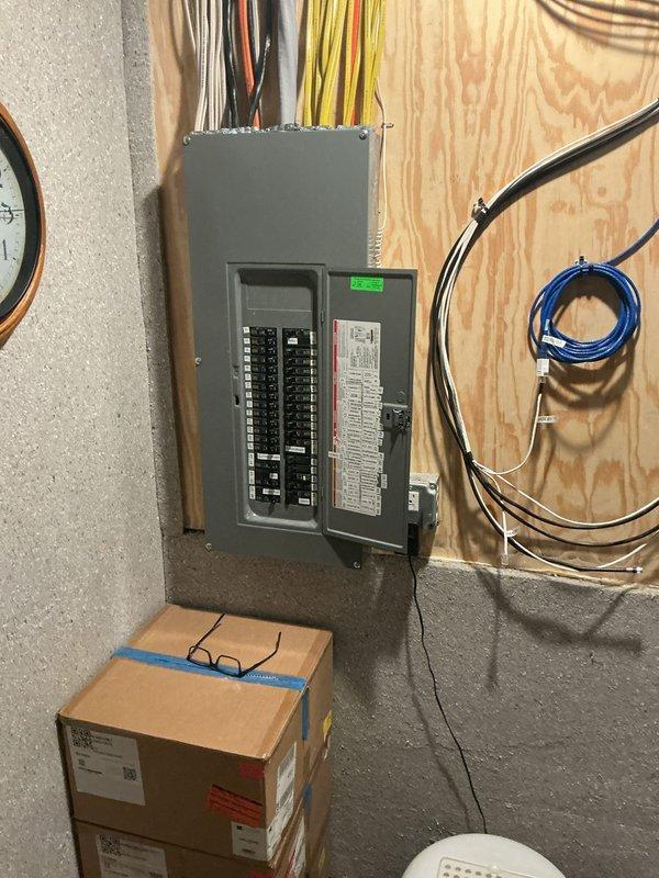 Conducted on-site evaluation for whole-house generator installation with focus on Kohler generator system. Assessed existing electrical infrastructure including main service panel with dual-row circuit breaker configuration and 240V 3-wire Consumers Energy meter rated at 30TA. Documented current electrical service capacity and panel layout to determine transfer switch placement requirements and load calculation needs for proper generator sizing. Photographed electrical panel interior showing multiple branch circuits and service entrance conductors, as well as exterior utility meter to verify service specifications for integration with automatic transfer switch system.