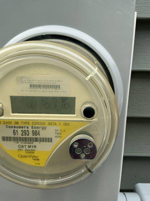 Conducted on-site evaluation for whole-house generator installation with focus on Kohler generator system. Assessed existing electrical infrastructure including main service panel with dual-row circuit breaker configuration and 240V 3-wire Consumers Energy meter rated at 30TA. Documented current electrical service capacity and panel layout to determine transfer switch placement requirements and load calculation needs for proper generator sizing. Photographed electrical panel interior showing multiple branch circuits and service entrance conductors, as well as exterior utility meter to verify service specifications for integration with automatic transfer switch system.