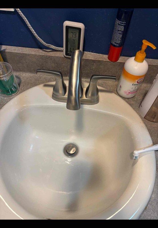 Completed comprehensive plumbing system upgrades including replacement of sewage ejection pump system with new pump, check valve, and sealed lid. Installed X-Tall Kohler comfort height elongated toilet in downstairs bathroom. Replaced existing well tank with new 44-gallon pressure tank to improve water pressure throughout the home. Installed new brushed nickel bathroom faucet to ensure optimal water flow and pressure delivery. All components tested and confirmed operational upon completion.