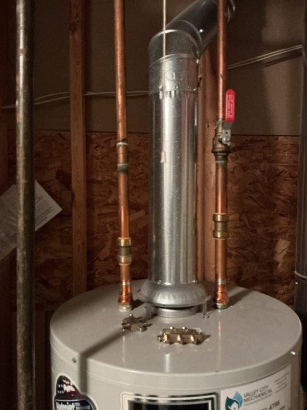 # Water Heater Repair - Lukewarm Water Issue

Responded to service call for water heater producing only lukewarm water. Upon arrival, inspected residential tank-style water heater with DEFENDER Safety System in basement utility area. Unit showed no visible leaks, unusual noises, or error codes displayed.

Performed diagnostic evaluation of heating system components. Checked thermostat settings and verified both upper and lower heating elements for proper operation. Tested temperature-pressure relief valve functionality and inspected all copper supply line connections for proper flow. Examined gas supply line (if gas unit) or electrical connections (if electric unit) for adequate delivery to heating components.

Identified heating element malfunction as primary cause of inadequate water temperature. Lower heating element showed signs of failure, preventing tank from maintaining proper temperature throughout full capacity. Upper element functioning but insufficient to heat entire tank vo