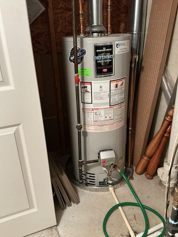 # Water Heater Repair - Lukewarm Water Issue

Responded to service call for water heater producing only lukewarm water. Upon arrival, inspected residential tank-style water heater with DEFENDER Safety System in basement utility area. Unit showed no visible leaks, unusual noises, or error codes displayed.

Performed diagnostic evaluation of heating system components. Checked thermostat settings and verified both upper and lower heating elements for proper operation. Tested temperature-pressure relief valve functionality and inspected all copper supply line connections for proper flow. Examined gas supply line (if gas unit) or electrical connections (if electric unit) for adequate delivery to heating components.

Identified heating element malfunction as primary cause of inadequate water temperature. Lower heating element showed signs of failure, preventing tank from maintaining proper temperature throughout full capacity. Upper element functioning but insufficient to heat entire tank vo