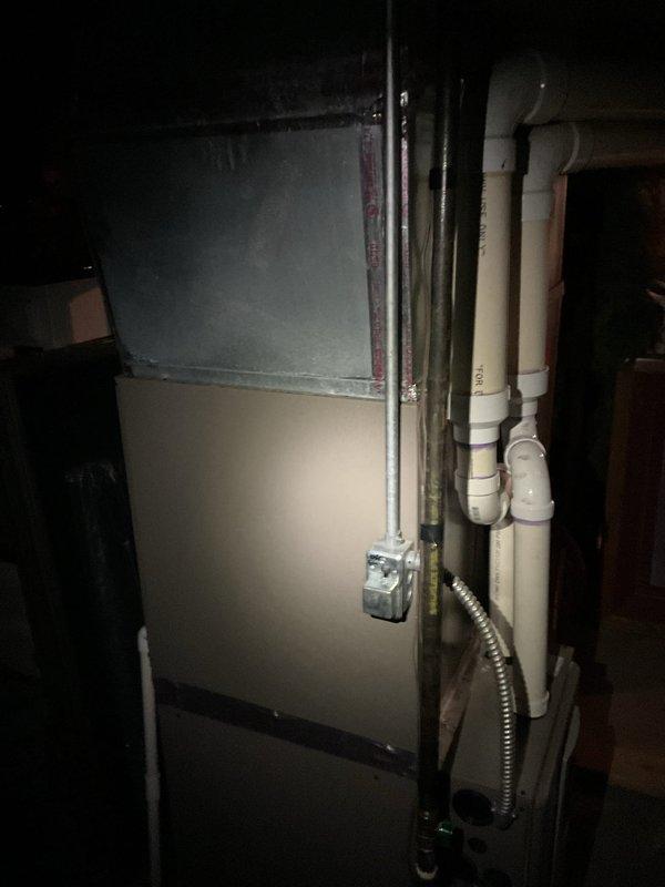 Responded to no cooling call on 12-year-old York system. Upon inspection, diagnosed leaking evaporator coil in indoor air handler unit located in basement mechanical room and confirmed outdoor condenser unit operational status. Documented equipment condition with photos of both outdoor condensing unit positioned on decorative rock bed against residence and indoor air handler cabinet with associated refrigerant piping and drainage lines. Provided estimate for evaporator coil replacement and related repairs necessary to restore system functionality.