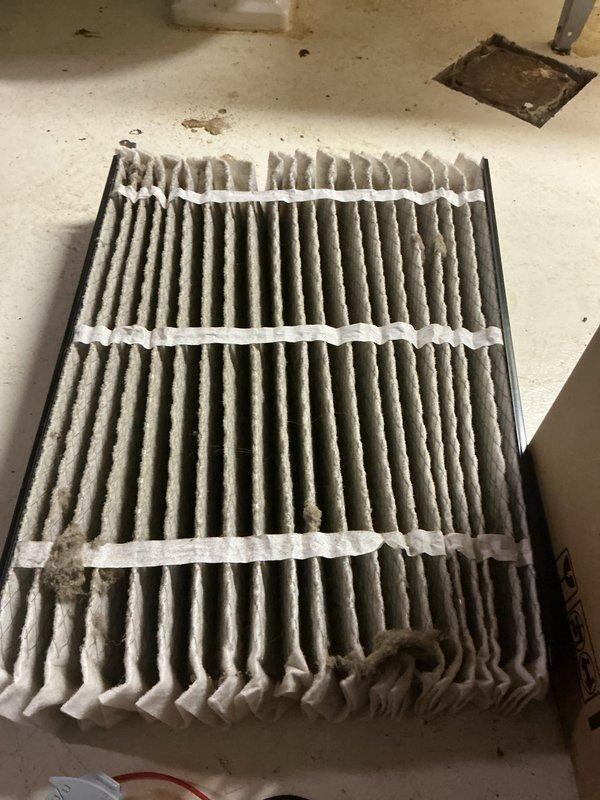Completed annual cooling maintenance on EnergiAir system (Model WT 03-2035, installed 2023). Replaced heavily soiled air filter that showed significant accumulation of dust and particulate matter with visible compression damage to pleated structure. Inspected condensate drain system including PVC trap configuration and drain pan; confirmed proper drainage and no leaks present. Verified HVAC unit operation and documented equipment condition with photos. System operational upon completion.