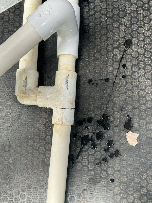 # CP-Cooling Problem Resolution

Responded to service call for air conditioning system not cooling to set temperature with water accumulation in drain pan. Upon inspection, identified condensate drainage issue affecting system performance. Located condensate drain line assembly in crawl space showing signs of blockage and improper drainage. Examined PVC drain piping configuration with visible discoloration and staining around joint connections, indicating chronic moisture problems and potential biofilm buildup restricting flow.

Cleared condensate line obstruction and verified proper drainage function. Inspected drain pan for cracks or damage. Tested system operation and confirmed air conditioning unit now cooling properly to set temperature with condensate draining freely through cleaned drain line. System restored to normal operation with proper drainage function established.