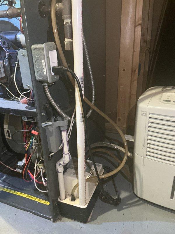 Completed annual heating and cooling maintenance on 18-year-old Goodman furnace and air conditioning system. Performed comprehensive tune-up including inspection of gas valve assembly, heat exchanger, burner components, electrical connections, and refrigerant lines. Verified proper operation of both heating and cooling systems, confirmed all safety controls functioning correctly, and documented equipment condition with photos showing internal components and HVAC installation in mechanical room.