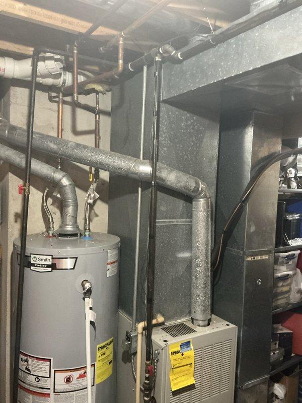 Completed estimate for replacement of 28-year-old non-functional air conditioning system and operational furnace in basement mechanical room. Customer requested both units be replaced simultaneously for system compatibility and efficiency. Documented existing equipment conditions including aged furnace with active combustion chamber, deteriorated ductwork, and associated HVAC components through photographic assessment for replacement proposal.